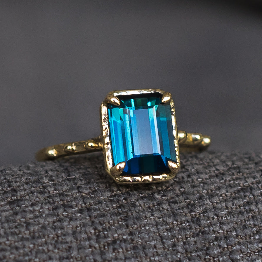 Emerald cut blue tourmaline gold ring